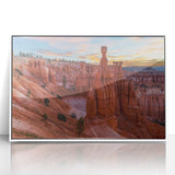 Acrylic print of Bryce Canyon in muted orange and red tones, framed in white, suitable for modern art wall decor.