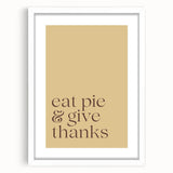 Abstract art print of autumn leaves in warm orange and red tones, framed in white, suitable for dining room decor.