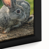 Close-up of a black framed canvas featuring a textured, colorful abstract design, ideal for living room decor.