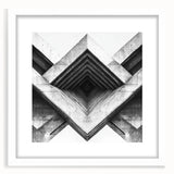 Abstract art print featuring geometric shapes in muted gray and blue tones on a white framed canvas.