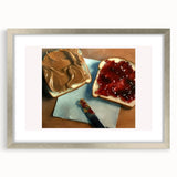 Textured art print featuring an abstract design of pastries in muted brown and cream tones, framed in silver.