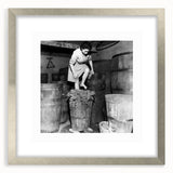 Textured art print featuring abstract shapes in muted earth tones, framed in silver, ideal for bedroom ambiance.