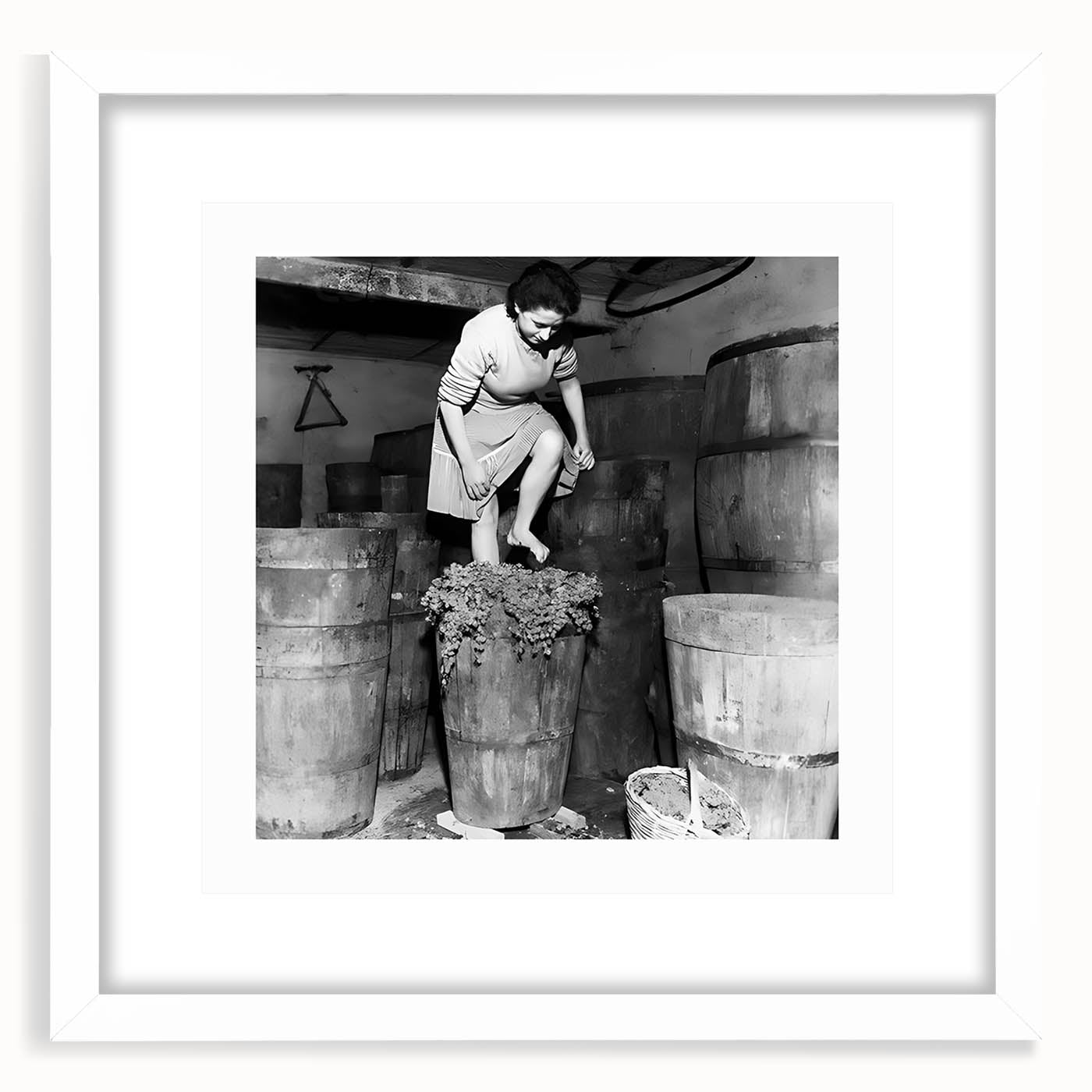 Abstract art print featuring silhouetted figures and food items in muted earth tones, framed in white.