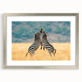 Abstract art print depicting African scenery in earth tones on a silver-framed mat, ideal for dining room decor.