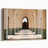 Framed canvas featuring a vintage-style landscape painting of a Moroccan scene in vibrant gold and black tones.