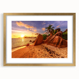 Abstract art print of Seychelles scenery in muted blue and green tones, framed in gold.