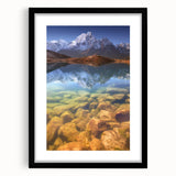 Colorful abstract art print of a textured Nepal scenery in vibrant hues, framed in black, ideal for living room decor.