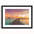 Extra large abstract art print of a colorful Caribbean scene on textured canvas, framed in black.