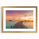 Abstract art print of Caribbean scenery in gold frame, featuring vibrant blue and green tones, ideal for dining room decor.