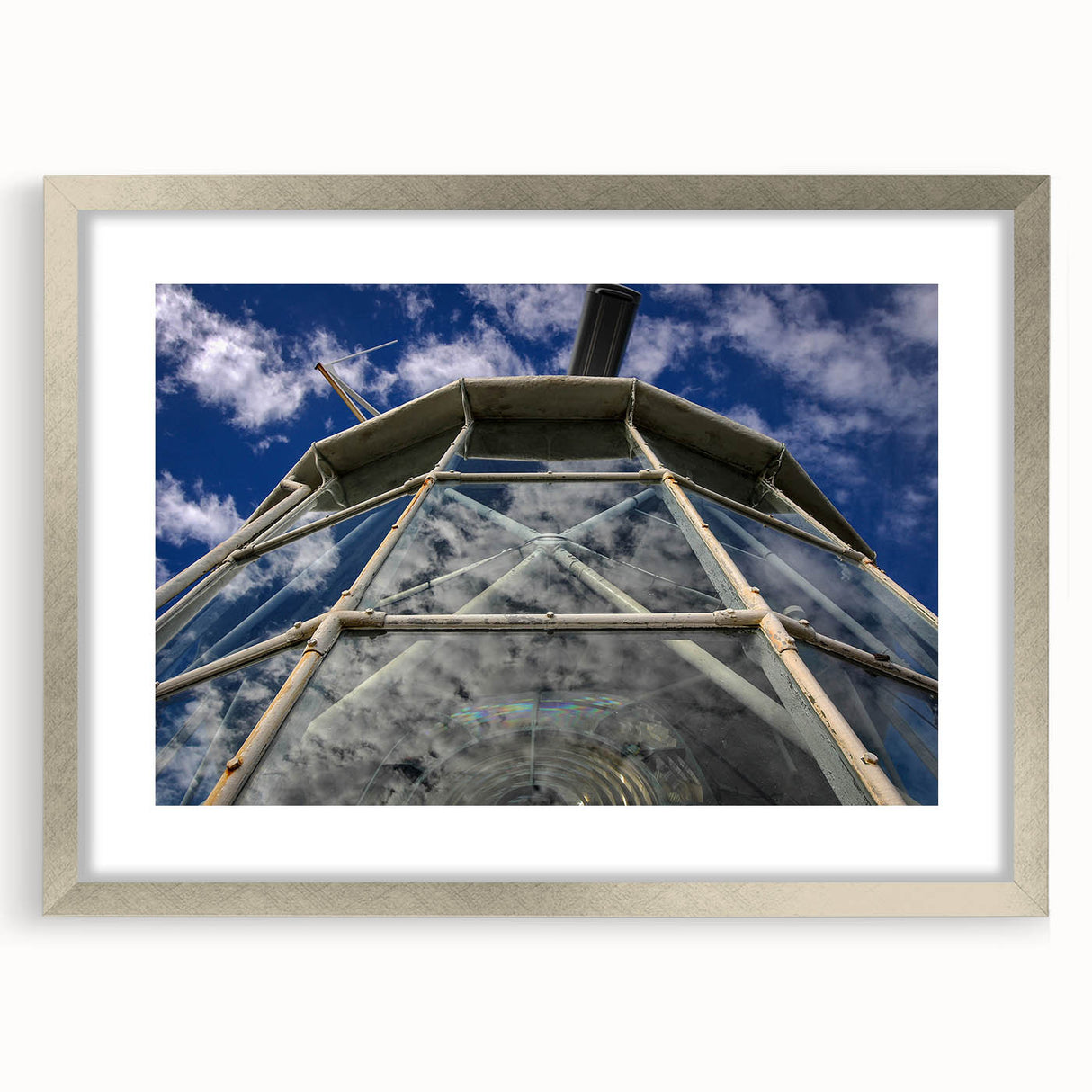 Abstract art print of Caribbean scenery in muted blue and green tones, framed in silver, ideal for dining room decor.