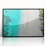 Large abstract wall art of a Caribbean scene in muted blue and green, framed in black acrylic.
