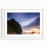 Abstract art print of Caribbean scenery in muted blue and green tones on a framed white mat, ideal for dining room decor.