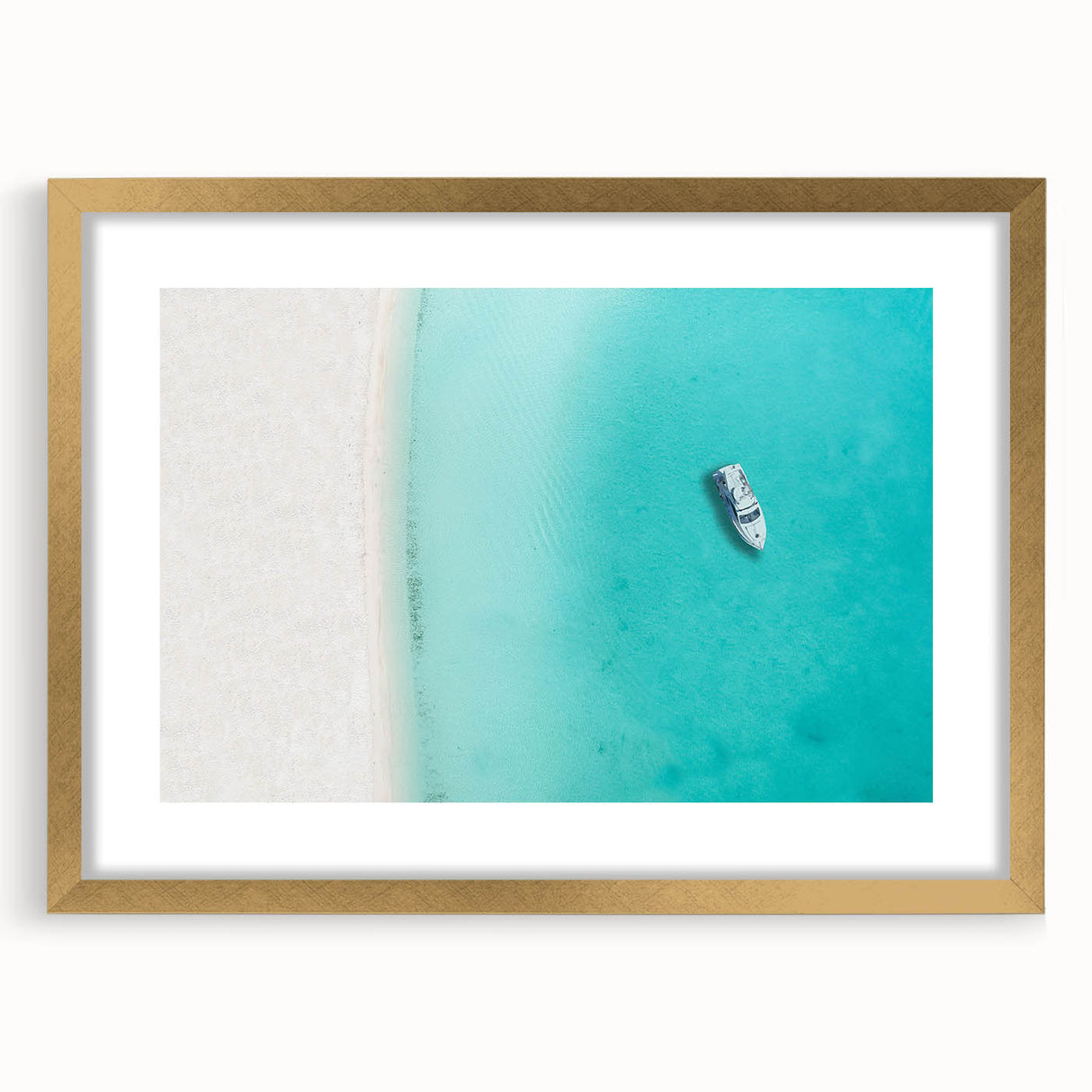 Abstract art print of Caribbean scenery in gold frame with mat, featuring serene blue and white tones.