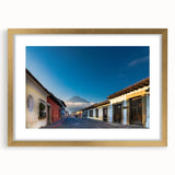 Extra large abstract art print depicting a textured Central American scenery in muted earth tones, framed in gold.