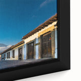 Extra large black wall art depicting a textured, colorful Central American scenery on a framed canvas.