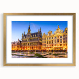 Abstract art print of a European landscape in muted gold and green hues, framed with a gold mat.