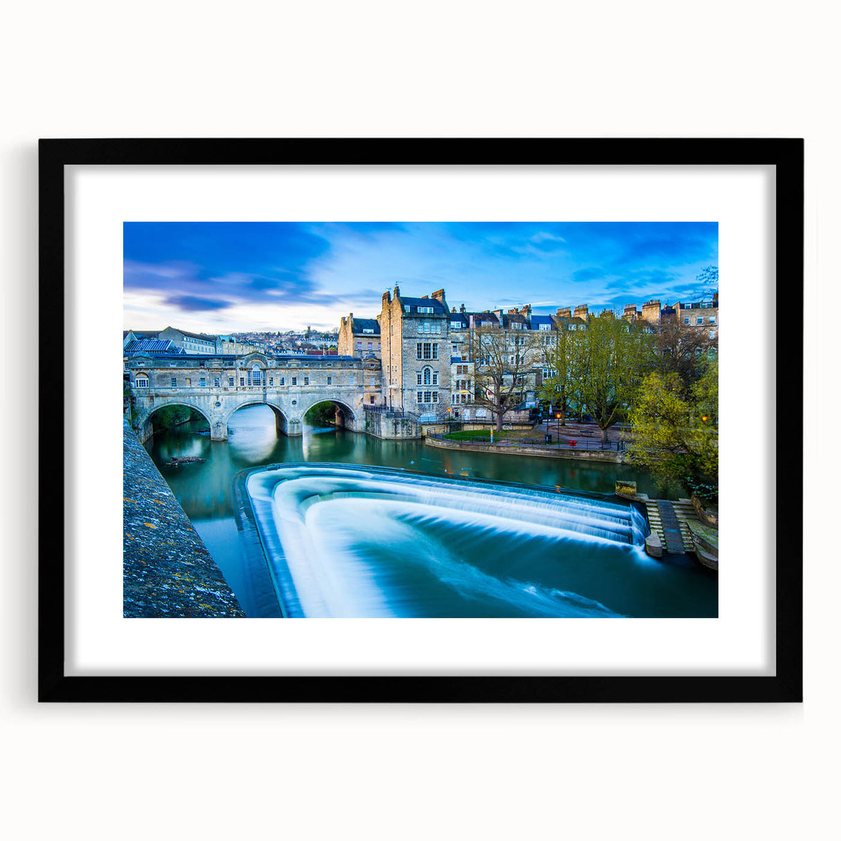 Abstract art print of colorful, textured scenery, framed in black, ideal for living room decor.