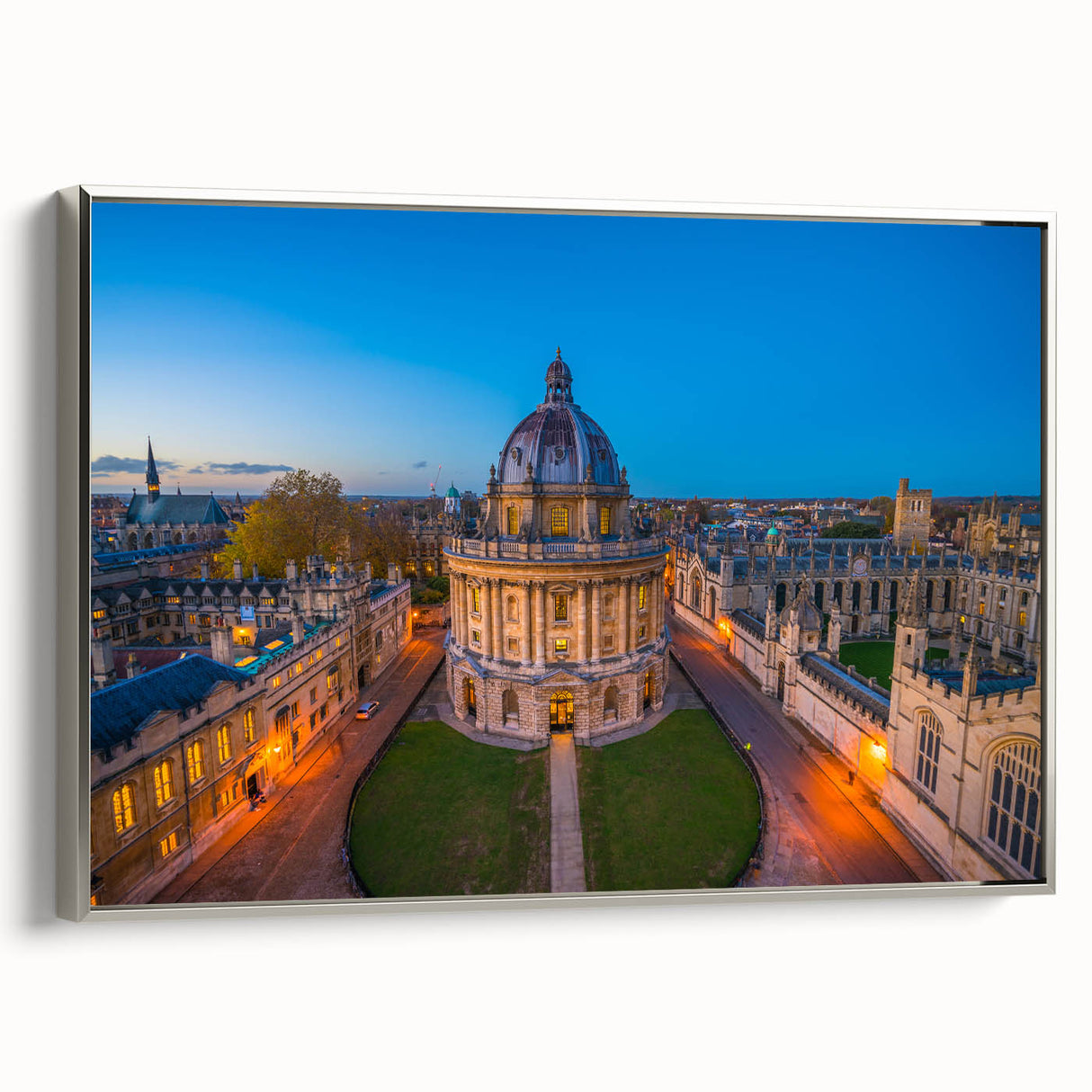 Landscape painting of Oxford with colorful buildings and a black sky on a framed canvas, suitable for office decor.