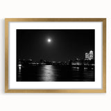 Abstract art print of the Thames River with muted blues and grays, framed in gold, suitable for dining room decor.