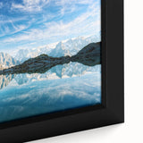 Black wall art featuring a textured depiction of the French Alps in vibrant colors on a framed canvas.