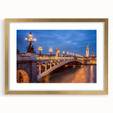 Abstract art print of Paris skyline in muted gold and blue tones, framed with a gold mat, suitable for dining room decor.