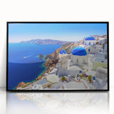 Large abstract wall art featuring the Santorini landscape in muted blue and white hues, framed in black acrylic.