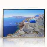 Acrylic print of Santorini with white buildings and blue roofs, in gold frame, ideal for modern art wall decor.