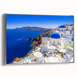 Framed canvas of a vintage-style Santorini landscape painting, featuring vibrant blue and white tones.