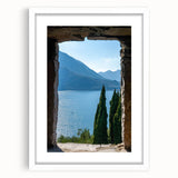 Textured abstract art print of Lake Como with muted blue and green tones on a framed white mat, ideal for bedroom art.