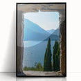 Large abstract wall art depicting Lake Como with muted blue and green tones, framed in black acrylic.