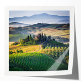 Rolled print of a Tuscan landscape with vibrant green fields under a clear sky, ideal for art wall dining room decor.