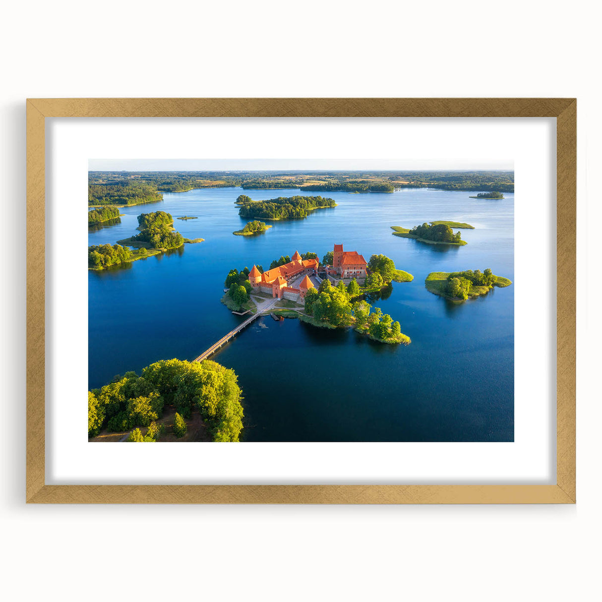 Abstract art print featuring a European landscape in muted gold and green tones on a framed canvas.