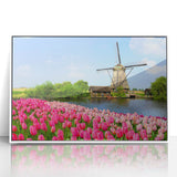 Mid-century modernist art of a European landscape in muted greens and blues, acrylic print framed in white.