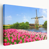 Side view of a stretched canvas featuring a serene European landscape in muted green and blue tones.