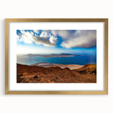 Abstract art print of a European scenery in muted gold and blue tones, framed with a gold mat.