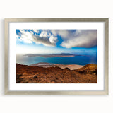 Extra large abstract art print depicting a textured European scenery in muted earth tones, framed in silver.