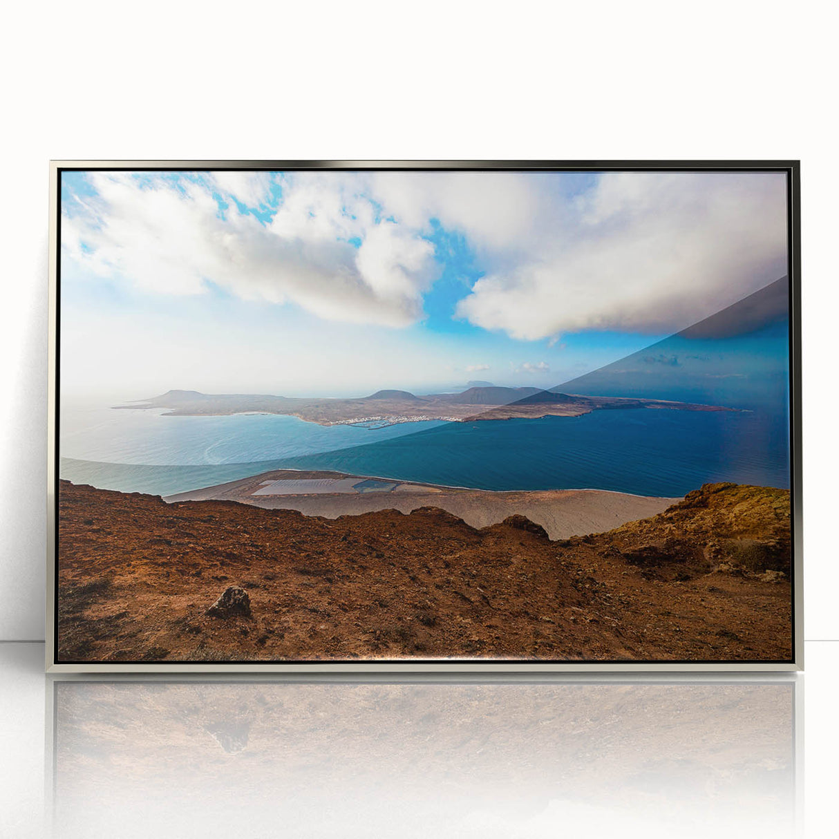 Large art print of a serene Canary Islands landscape in subdued blues and greens, framed in silver acrylic.