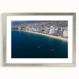 Textured abstract art print of Acapulco scenery in silver frame with mat, featuring vibrant blue and green hues.