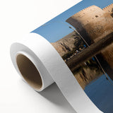 Art deco poster of Middle Eastern scenery on rolled canvas, featuring muted earth tones.