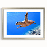 Textured abstract art print of an oceanic Fiji scene in muted blue and teal, framed in silver, suitable for bedroom decor.