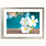 Textured art depicting abstract oceanic scenery in cool blue and green tones on a silver-framed canvas.