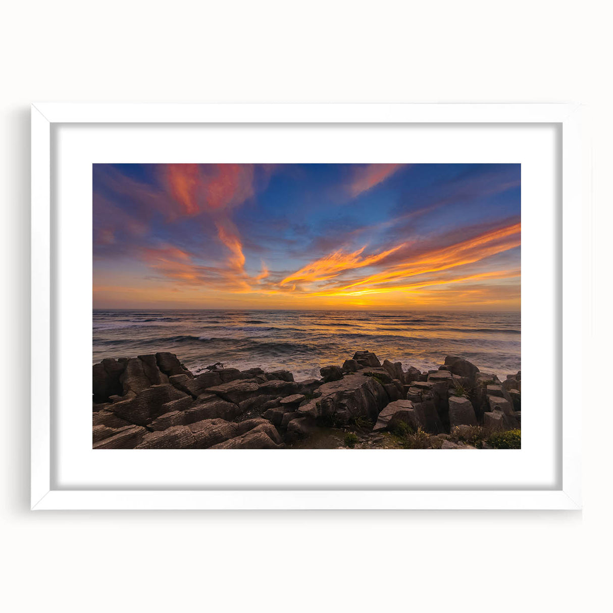 Abstract art print depicting New Zealand's West Coast in muted blue and green tones, framed with a white mat.