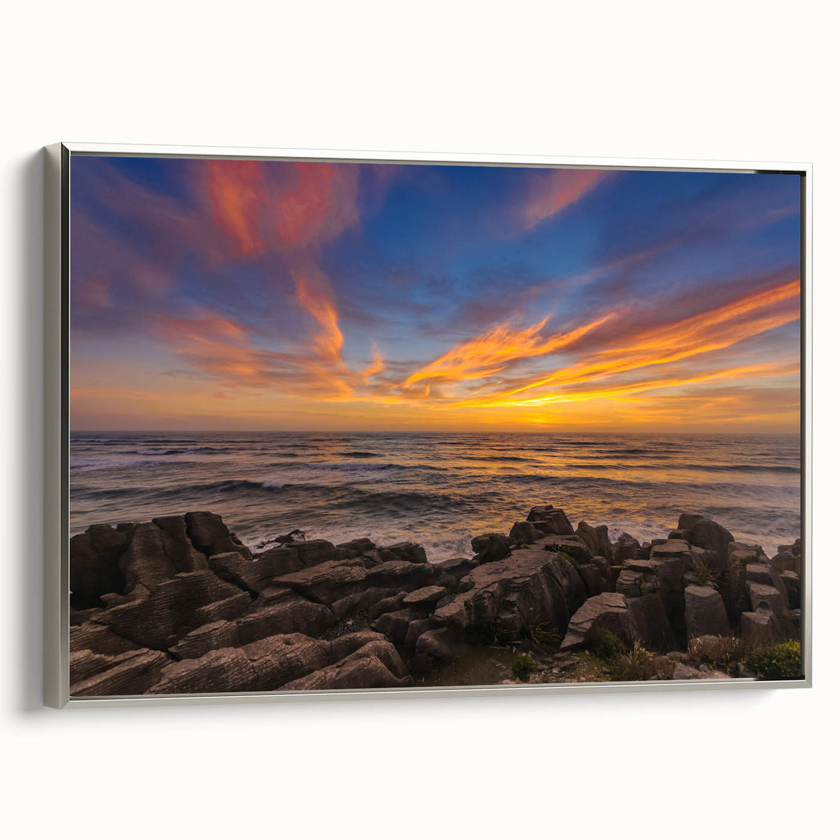 Landscape art painting of New Zealand's west coast in vibrant colors on a silver-framed canvas, ideal for living room decor.