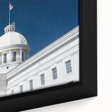 Close-up of black wall art featuring a textured Alabama scenery in vibrant colors on a framed canvas.