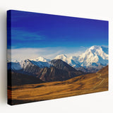 Large canvas print depicting the Denali mountain range in Alaska, utilizing muted earth tones, suitable for kitchen wall art.