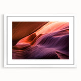 Abstract art print of Antelope Canyon in Arizona, featuring swirling orange and red rock formations on a framed white mat.