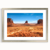 Textured art print of Monument Valley in muted earth tones on a framed canvas, suitable for bedroom decor.
