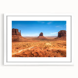 Abstract art print of Monument Valley in muted earth tones on a white-framed mat, ideal for dining room decor.