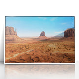 Acrylic print of Monument Valley with vivid orange and red tones, framed in white, suitable for modern art wall decor.