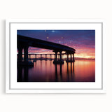 Abstract art print depicting the Coronado, California skyline in muted blue and gray tones on a framed white mat.